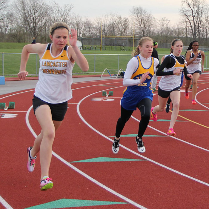 student athletes running on track